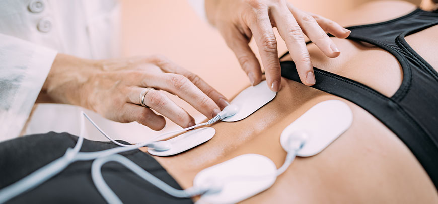 patient receiving electrical muscle stimulation in New Braunfels for auto accident injury relief
